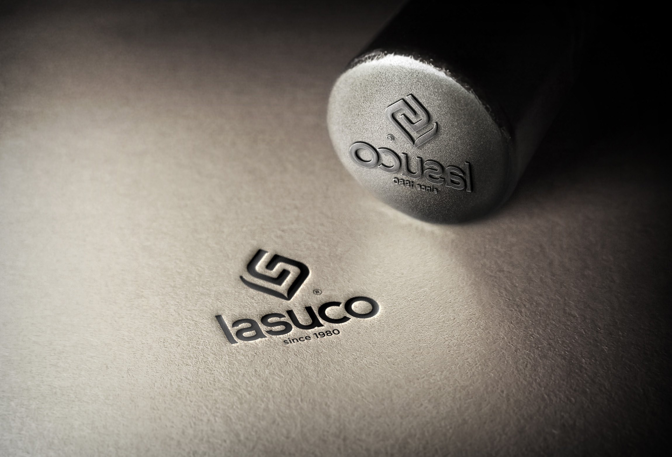 The Lasuco “since 1980” logo embossed on paper