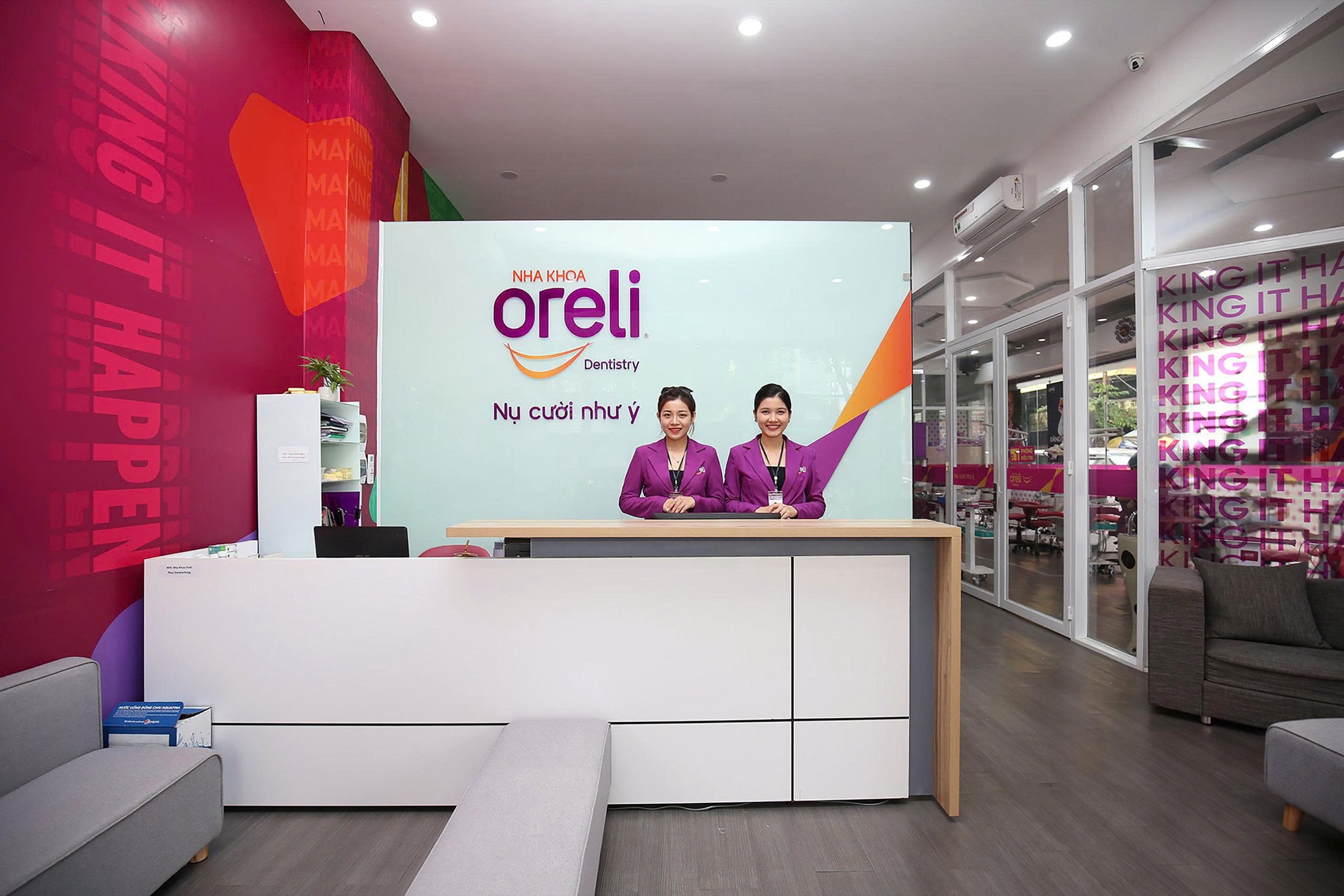 The Oreli Dental Clinic reception desk with the logo and the tagline “The smile you wish for”