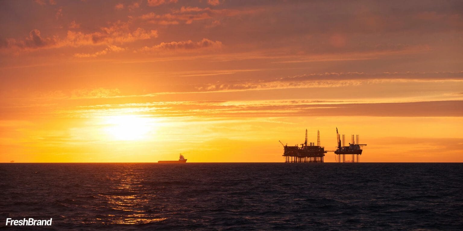 An offshore drilling rig at sunset